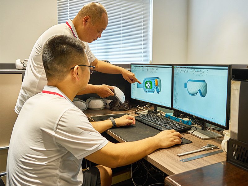 Kaisum engineers working on an eye massager housing