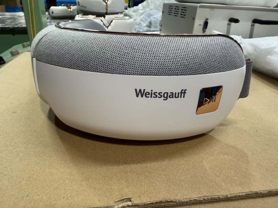 Kaisum eye massager built for Weissgauff, white housing with chrome trim and a metal badge